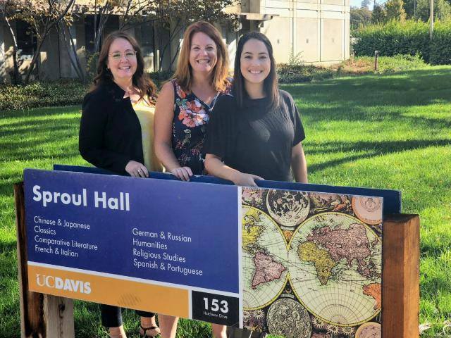 Your advising team standing behind a sign for sproul hall