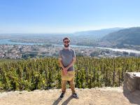 Cole Bacon stands overlooking a town in France