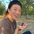A photo of a student with a small bird in their hands