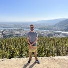 Cole Bacon stands overlooking a town in France.