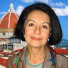 A woman's headshot with florence behind her