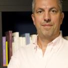 Eric Russell standing in front of a bookcase