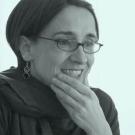Woman in scarf with her hand on her chin