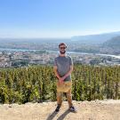 Cole Bacon stands overlooking a town in France